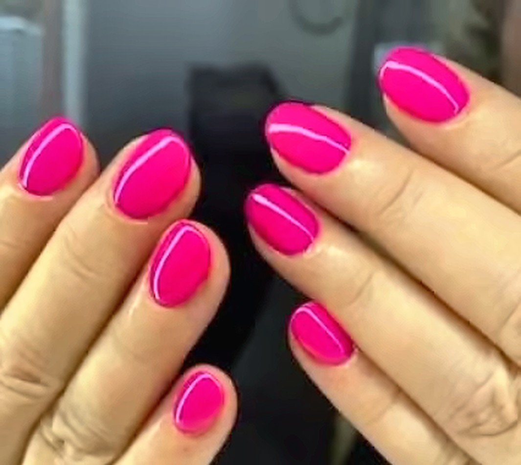 Neon pink nails with a fine white line